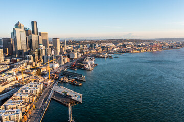 Seattle, Washington, USA - November 2022, aerial view of Seattle Downtown and the Waterfront pier area with The Seattle Great Wheel and Harbour Island with Container Terminal - aerial panoramic view 	