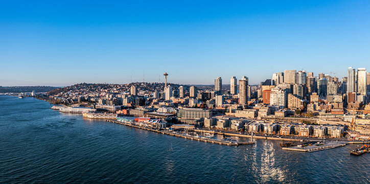 Seattle, Washington, USA - November 2022, aerial view of Seattle Downtown and the Waterfront pier area with the cruise ship terminal and the Space Needle Tower - aerial panoramic view 	