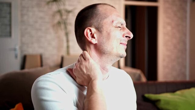 Man feels neck pain after woke up in morning, uncomfortable matrass, closeup