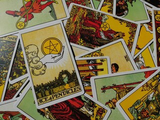 Picture of the Ace of Pentacles tarot card from the original Ride Waite tarot deck with mixed tarot cards in the background