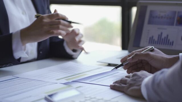 Group of business men and women holding statistical data and charts of brainstorming financial reports. Financial analysis with the manager of a large company. 4k video