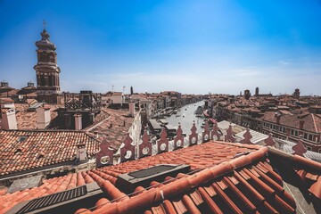 Grand canal from the red rooftops of ancient buildings in Venice