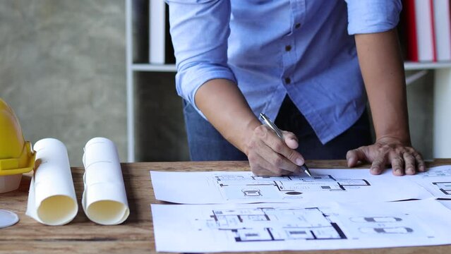 Architects in the office work on designing plans for construction projects.