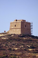 Vertical shot of the stone building on the hill