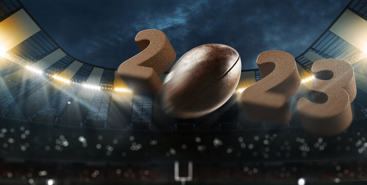 Flight of american football ball through dark evening stadium with spotlights. Concept of sport, competition, energy, power. 2023 new year