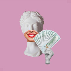 Antique female smiling statue's head holds a wad of hundred-dollar cash banknotes isolated on a...