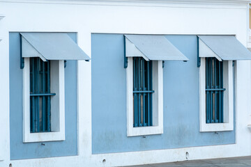 Rectangular windows of an old vintage French era building in the town of Pondicherry in South India.