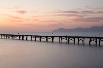 Fototapeta na wymiar Long pier in the sea at sunset