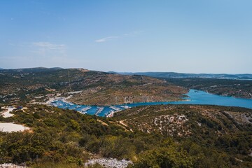 Obraz premium Scenic view of the beautiful landscape of Primosten, Croatia against a blue sky