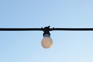 Hanging round white bulb with a natural backdrop. decorate outdoor of the house to celebrate and set the event.