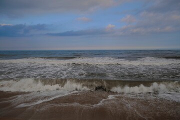 Beautiful view of a sea with small waves during sunset