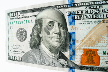This photo illustration of Ben Franklin with a black eye and bandages on a newly printed 100 dollar bill might illustrate inflation, bad economy, recession, or misguided leadership. - 545201974