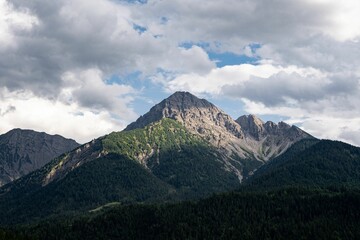 Landscape of beautiful rocky mountains with forested valley