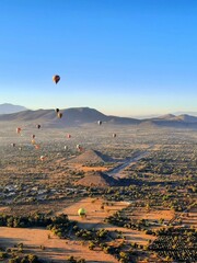 Eautiful view of ballons on the air and Teotihuacan Pyramids on the horizon in Mexico