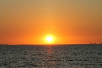 Beautiful orange sunset over gray sea dines, perdect for wallpaper
