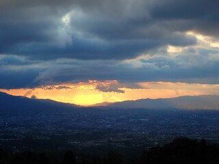 Beautiful scene of cityscape view under sunset dramatic sky on the horizon