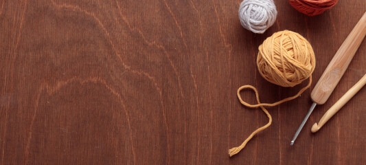 Cotton Yarn Balls for Crocheting Handmade on a Light Colored Wooden background