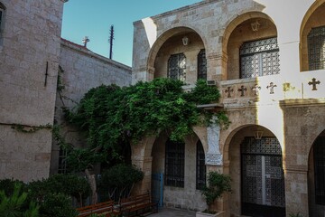 Fototapeta na wymiar Exterior of the Convent of Our Lady monastery with greenery in Saidnaya, Damascus, Syria