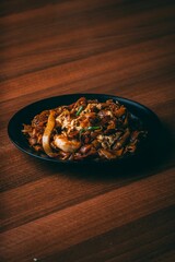 Vertical shot of a dish with shrimp and noodles