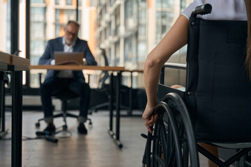 Fototapeta premium Female with disability coming to work in office
