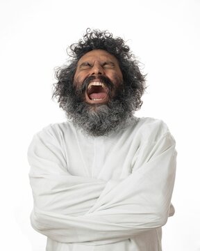 Crazy man expressing anger and discomfort in a straitjacket - the concept of mental illness and rage