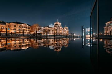 Reflection of the Reichstag building on the Spree River at night