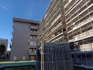 Scaffolding on construction site. Apartment complex under construction, no people.
