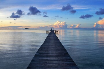 Wooden pier within colorful sunset - Raja Ampat, West Papua, Indonesia