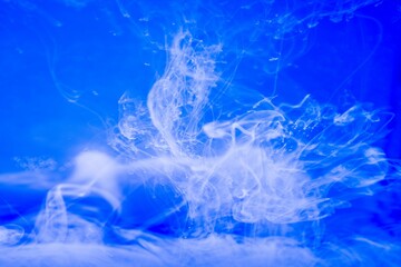 Smoke like shot of white ink in water for cool background