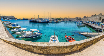 Fototapeta na wymiar Yachts and boats in picturesque port Mandraki marina, Rhodes, Greece