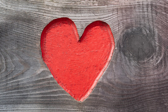 Romantic red heart in a wooden door plate