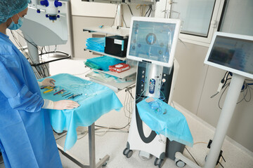 Female nurse preparing equipment for surgery in hospital