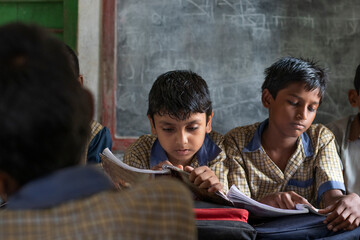 school boys studying in classroom
