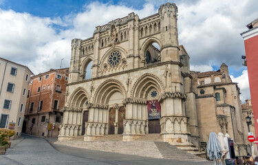Fototapeta na wymiar Front main facade view at the gothic classic building at the Cuenca Cathedral, an earliest Spanish examples of Gothic architecture, on Cuenca city downtown