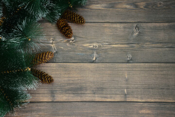pine cones and fir branches on dark wooden background isolated, close-up	