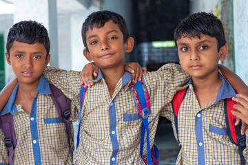 Three school friends with backpack at school