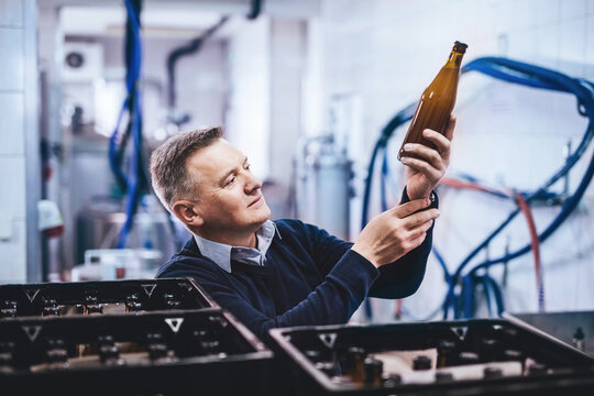 Man preparing craft beer from brewery for shipment.