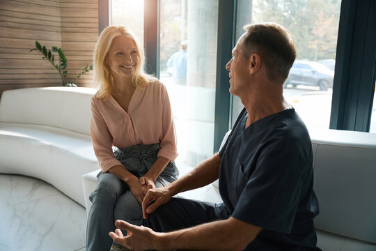 Adult male talking to happy beautiful woman