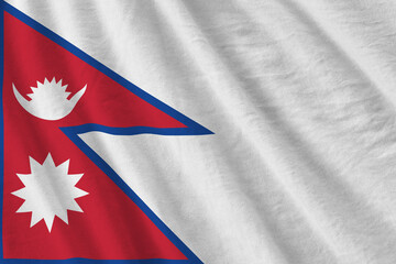 Nepal flag with big folds waving close up under the studio light indoors. The official symbols and...