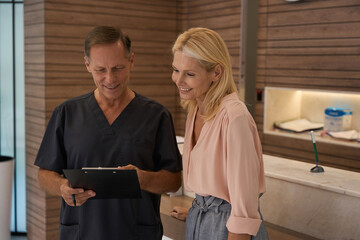 Man in medical uniform talking to beautiful woman