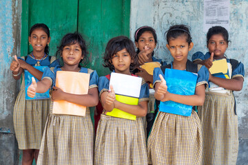 Group of School Girls  holding books showing thumps up