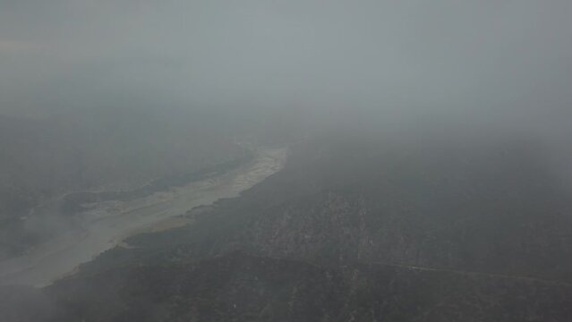 Aerial view of the misty river and mountains. Glendora, California, USA.
