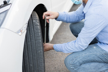 Car mechanic repairing a leaky tire wheel Mechanic changing tires on forklift using wrench to...