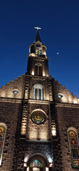 Matriz Church in the center of Gramado city, Rio Grande do Sul lit up at night on a beautiful day with a clear sky