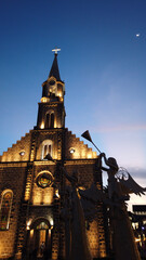 Naklejka premium Matriz Church in the center of Gramado city, Rio Grande do Sul lit up at night on a beautiful day with a clear sky