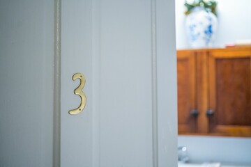 Selective focus of number "3" apartment  with a half-open door