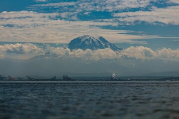 Scenic view of Mount Rainier at Puget Sound Bay on a cloudy day in Washington, USA