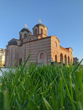 Selective focus of green grass against the St. Paraskeva in Prilep, North Macedonia