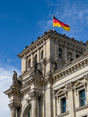 Fototapeta na wymiar German Parliament building in Berlin with German flag flying proudly above it.