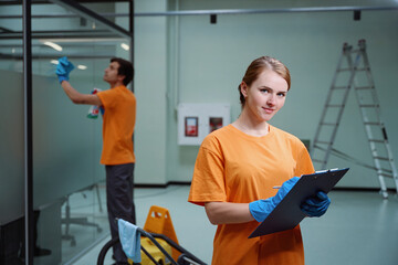 Professional cleaners accomplishing corporate request according to the checklist